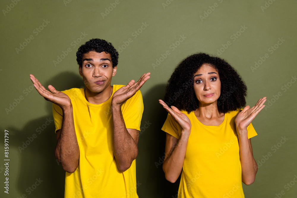 Sticker portrait of two nice people shrug shoulders wear t-shirt isolated on khaki color background