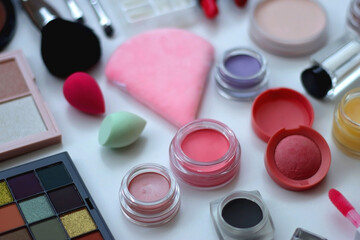 Various colorful beauty products on white background. Selective focus.