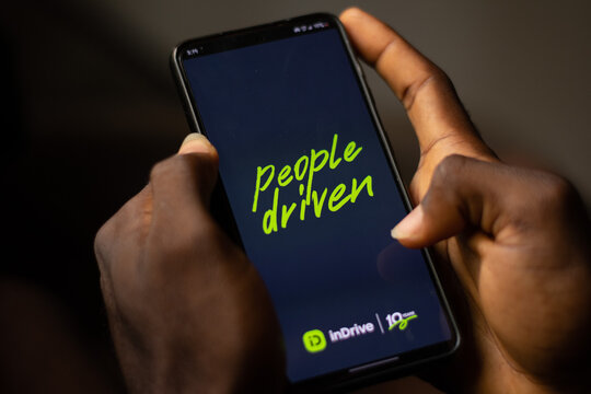 Lugbe, Abuja-Nigeria - April 22nd 2024: african person using indrive ride app