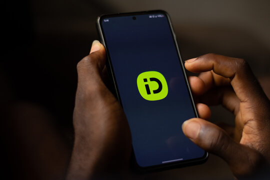 Lugbe, Abuja-Nigeria - April 22nd 2024: african person using indrive ride app