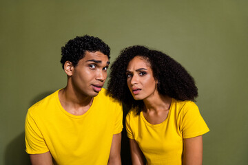 Fototapeta premium Portrait of two nice people think doubt wear t-shirt isolated on khaki color background