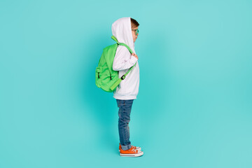 Profile side photo of fashion geek kid stand wait for lesson lecture in new schoolbag isolated cyan...