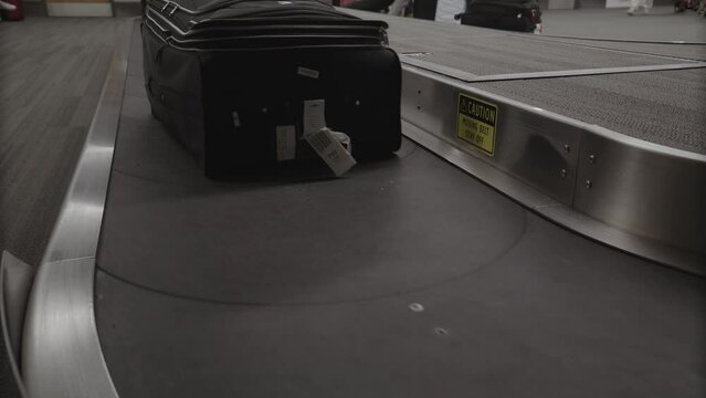 Luggage on airport baggage carousel approaching quickly / Provo, Utah, United States