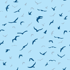 Flock of flying silhouette birds. Birds seamless pattern. White seagulls on a blue background.