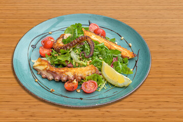 grilled octopus with rocket salad cherry tomatoes and roasted pine nuts