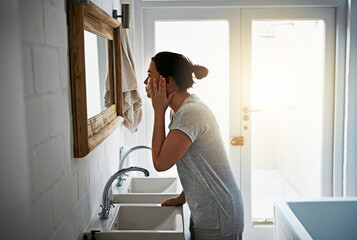 Home, bathroom and woman with mirror, cosmetics and skincare with anti aging, wellness and beauty....
