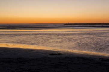 Fototapeta premium the colorful sunset view into the ocean at the beach of San Diego, California.