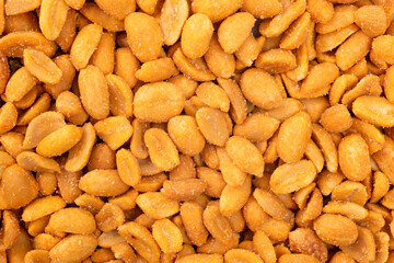 Spicy peanuts pile as background, top view. Chili spicy peanuts
