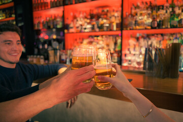 Friends toasting with drinks at a lively bar in the evening