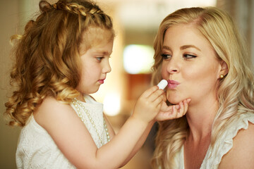 Lipstick, mother and child with makeup in home for beauty, care or family bonding together. Girl,...