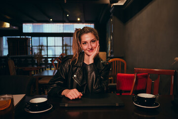 Young woman enjoying coffee in a cozy cafe during evening