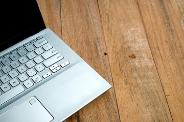 Laptop and space for text on wooden background