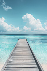 Fototapeta premium wooden beach pier leading into turquoise water of the maldives