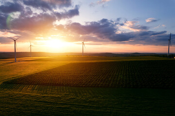 Windmill turbines generating green energy electric.Green energy helps reduce carbon emissions and...