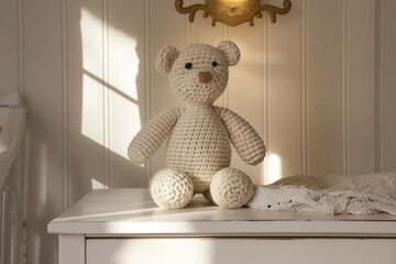 crochet teddy bear , A handmade crochet teddy bear doll sits atop a white drawer commode in a cozy baby room