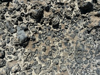 Solid lava rocks surface in the sun on the coast of El Medano, Tenerife, Canary Islands, Spain 
