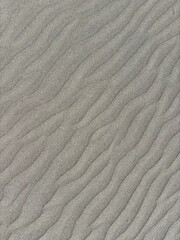 Gray volcanic sand dunes after windy weather and breeze in El Medano, Tenerife, Canary Islands, Spain 