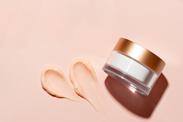 Pink peach cosmetic cream sample and jar