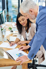 Fototapeta premium Asian woman, senior man and teamwork for report by desk with explain for helping, collaboration and writing notes. Employees, training and working together for marketing agency with pc and notebook