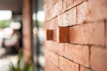 Close-up at orange clay stone brick wall of the retro style building exterior. 