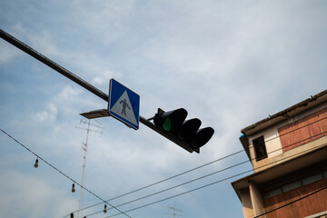 Pedestrian traffic crossing light in green signal at the urban city road. Transportation safety...