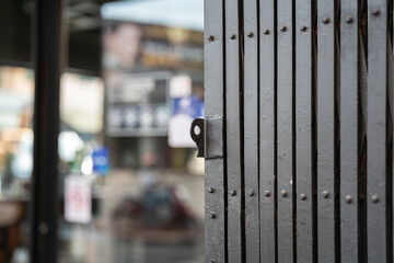 Classic style sliding metal fence gate, it using for cover the glass wall inside. Building place object photo, close-up and selective focus.
