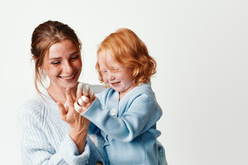 Mother and daughter embracing in joyful moment on white background with smiles love, family, togetherness and happiness concept