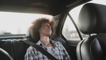 Beautiful woman sleeping in car back seats with safety belt. Slow motion