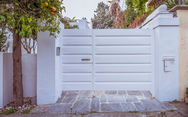 A modern design house garage white painted door in the upscale suburbs of Athens. Travel to Greece.