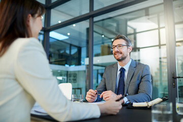 Businessman, meeting and interview with client for partnership, b2b or hiring at office. Business people or intern talking to executive for recruiting, discussion or explaining contract at workplace
