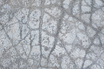 Gray cement surface with cracks
