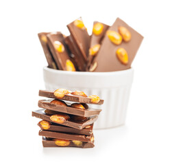 Broken chocolate bar with almonds isolated on white background.