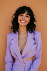 smiling woman with black hair wearing pastel purple summer suit, brown solid color background