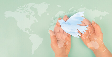 Dove flying from hand, international peace day, faith, freedom, charity and help concept, humanitarian aid, world map