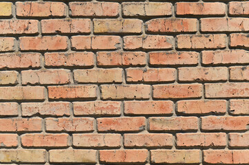 A red brick wall abstract background or texture, new and clean. for pattern background. wide panorama picture. on a bright sunny day with shadows.
