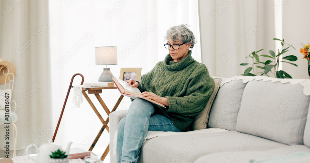 Canvas Prints Woman reading funny book in living room for story, novel and knowledge in retirement. Happy senior female person relax with books in lounge for break, literature and hobby to enjoy on sofa at home