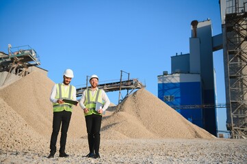 Two engineers at an industrial plant. Crushed stone production plant. Gravel