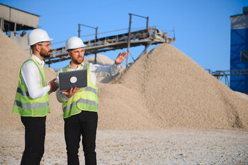 Two engineers at an industrial plant. Crushed stone production plant. Gravel