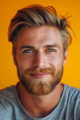 Fototapeta premium Front view portrait of mature man with beard on orange background