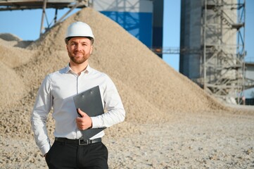 Engineer on an industrial background. Stone crushing and screening plant
