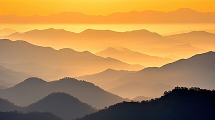 Obraz premium Sunrise over a serene mountain range, bathed in soft, golden light