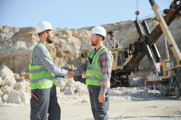 Workers talking in rock quarry