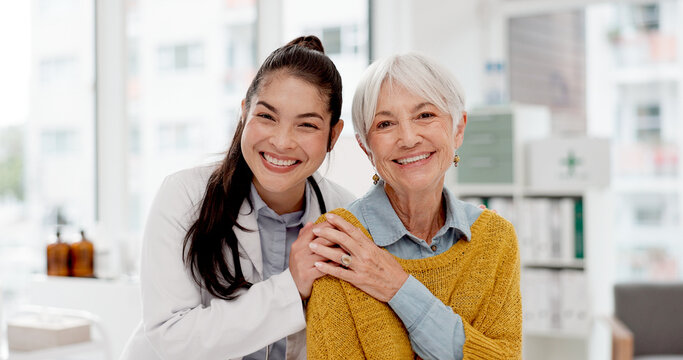 Happy, hug and face of a doctor with a woman for medical trust, healthcare and help. Laughing, care and portrait of a young nurse with a senior patient and love during a consultation at a clinic