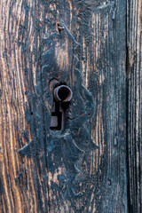 Vintage and retro door lock on burnt wood texture