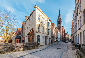Narrow street with terraced houses in city center of Bruges, Belgium.