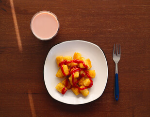 Overhead shot of tasty tator tots and a glass of chocolate milk