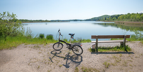 resting bench and bike beside, lake shore Seehamer See, upper bavaria