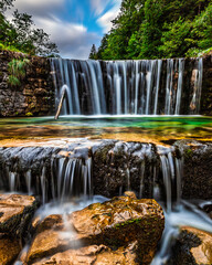 Obraz premium Waterfall Nature Landscape Long Exposure with Rocks and Forest, Tranquil Scenic Outdoors