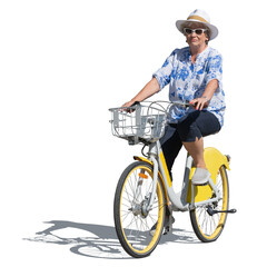 Older woman wearing a hat and colorful outfit riding a bike in summer isolated on white background