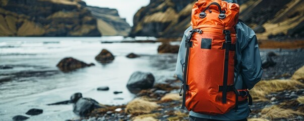 Focus on waterproof and robust rescue packs equipped for highstakes environments, set against the backdrop of a challenging terrain